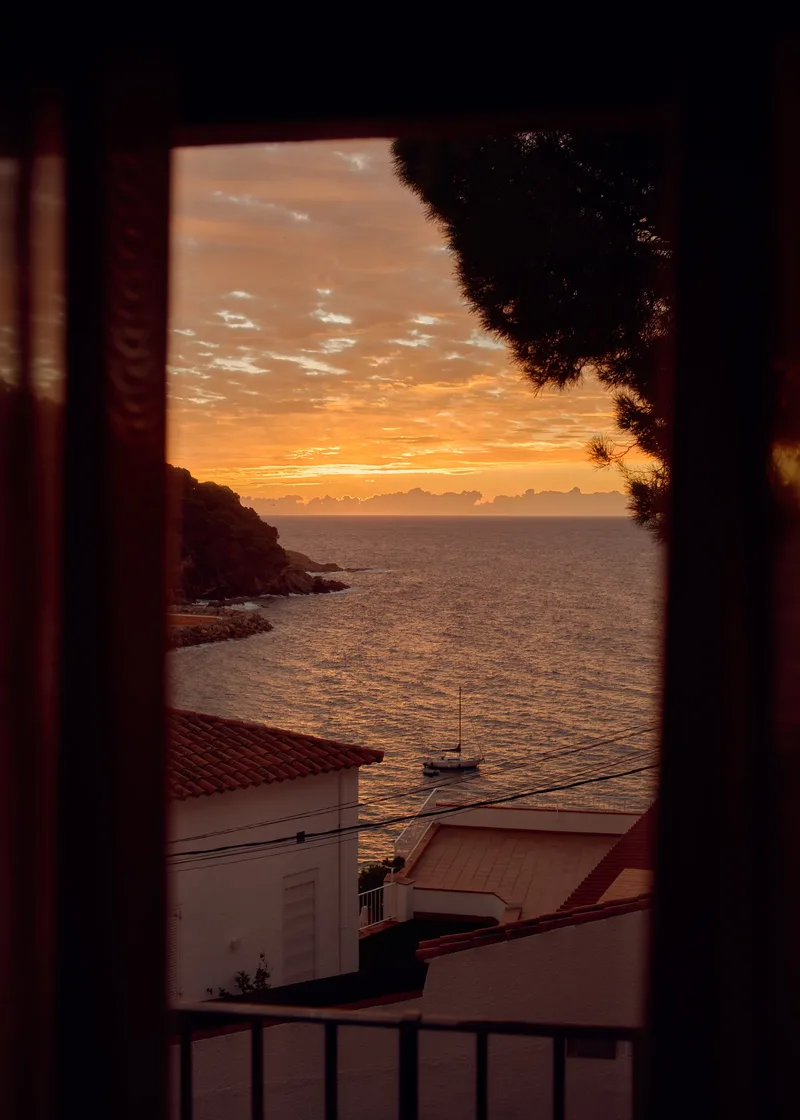 Sonnenuntergang über dem Meer mit Boot, Costa Brava, Reisefotografie von Wim Jansen Delgado